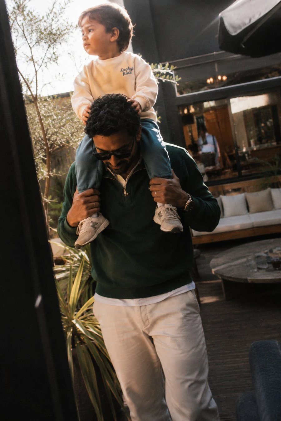 A father carrying his son on his shoulders at the club
