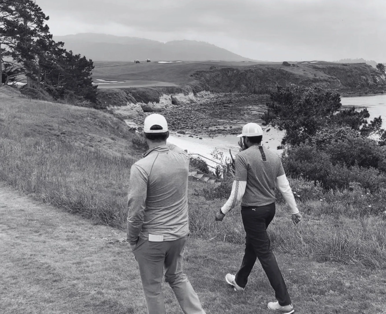 Shankar and Ryan walking the coastal course, overlooking the cliffs and bunkers below
